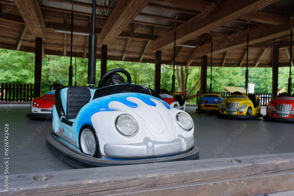 Obraz premium Colorful bumper cars parked inside outdoor amusement zone