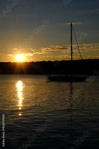 Serene Sunset with Silhouetted Sailboat