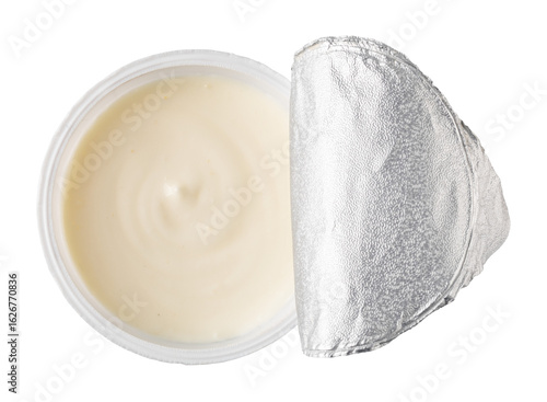 Plastic container of yogurt with foil lid partially peeled back on transparent background