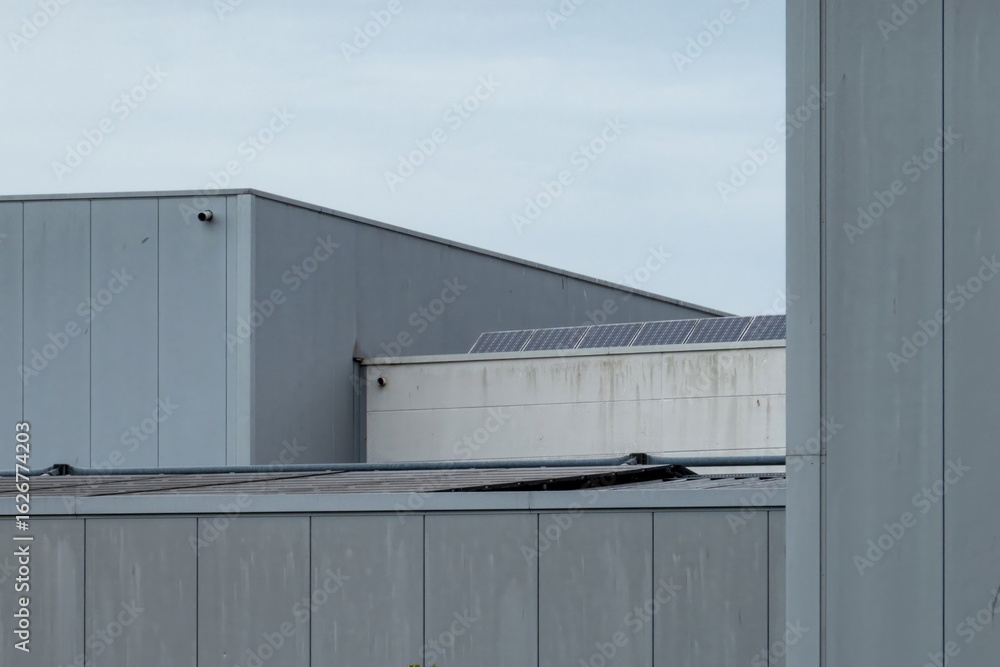 Fototapeta premium Industrial building showing solar panels on cloudy day