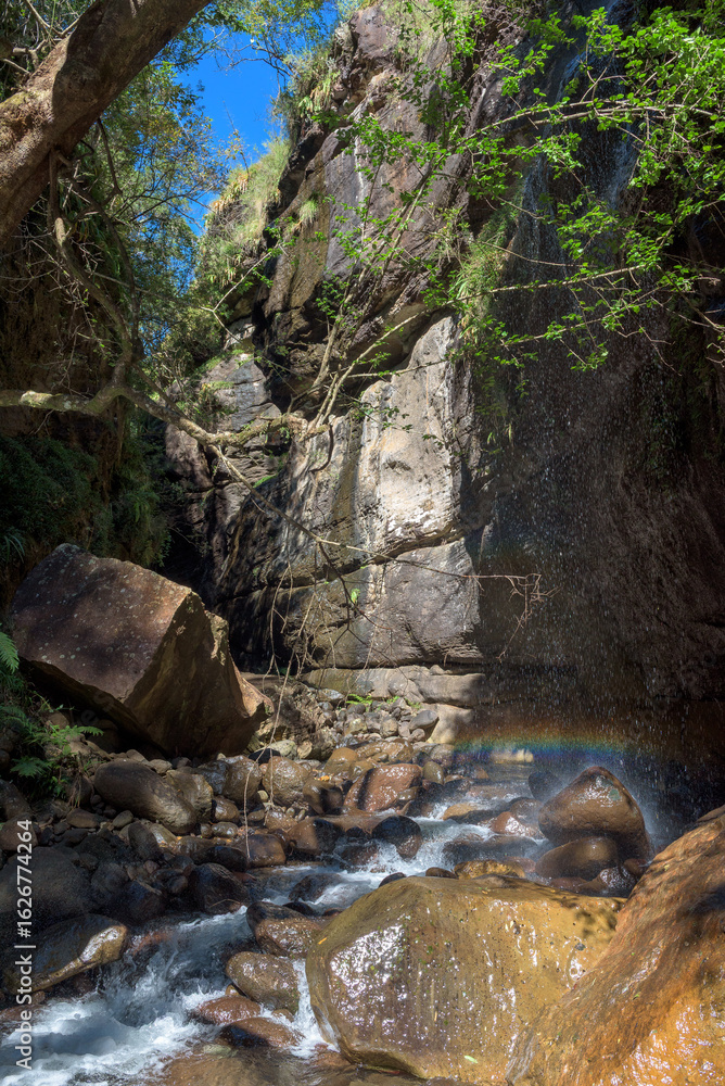 Fototapeta premium Falling water gives streaky rainbow in Rainbow Gorge
