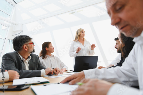 Business team meeting, female leader inspiring her colleagues