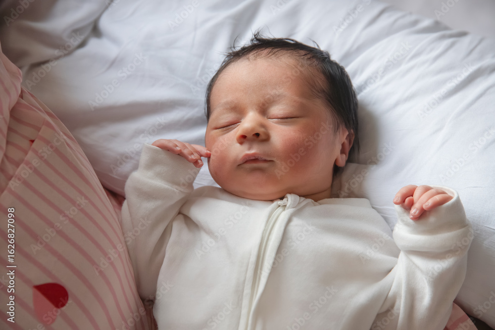 Peaceful newborn resting comfortably on white pillow Peaceful newborn resting comfortably on white pillow