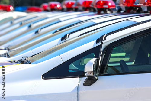 Police vehicles lined up during daytime for community safety operations in urban area