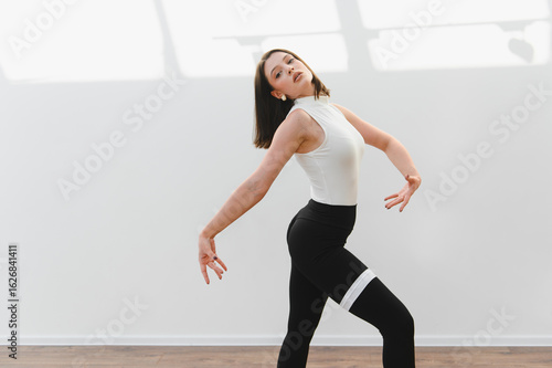 Photography Young talented woman dancing modern choreography in studio