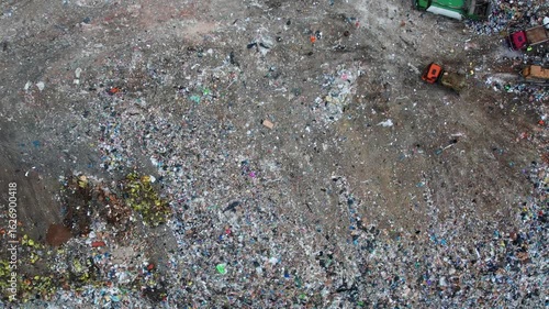Aerial view Garbage truck unloads rubbish in landfill of big city. Concept global problem of waste plastic pollution.