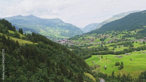 Aerial View of Grindelwald, Switzerland with Lush Green Hills and Swiss Alps