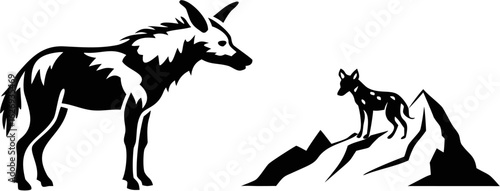Silhouette image of two african wild dogs one standing on mountains and the other on plain ground