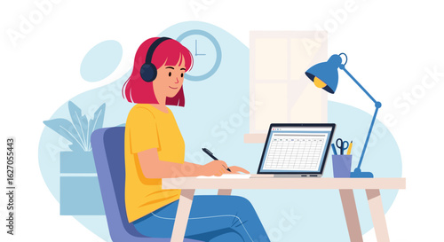 A young woman with headphones is diligently working on her laptop and writing notes at a home desk, embodying modern remote productivity and online learning.