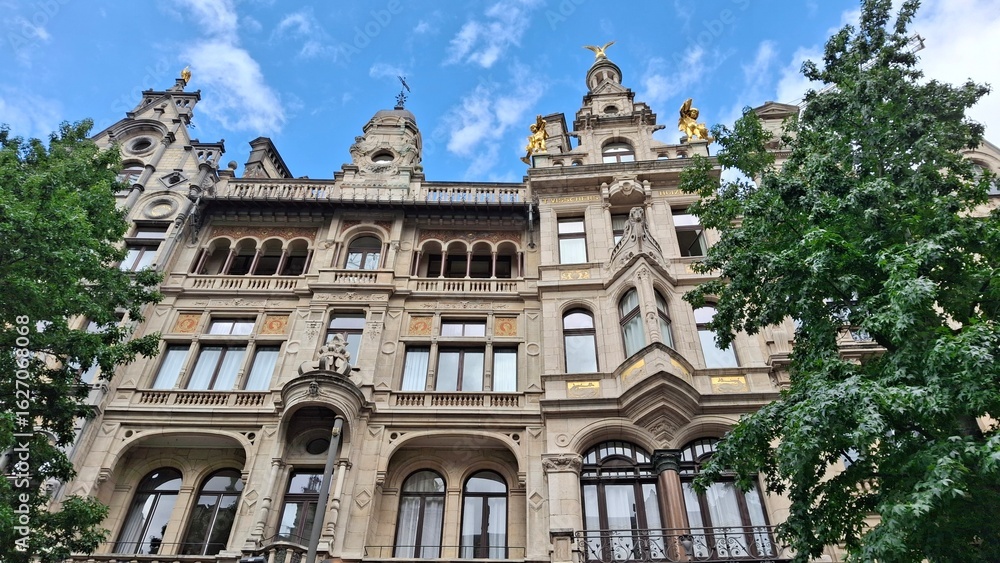 Historic European Facade with Sculptures and Golden Statues in Antwerp, Belgium Historic European Facade with Sculptures and Golden Statues in Antwerp, Belgium