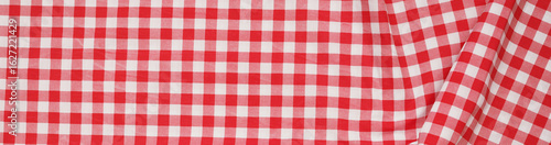 Closeup of a red and white checkered napkin or tablecloth texture. picnic cloth crumpled. Food decor element. Kitchen accessories. Top view background.