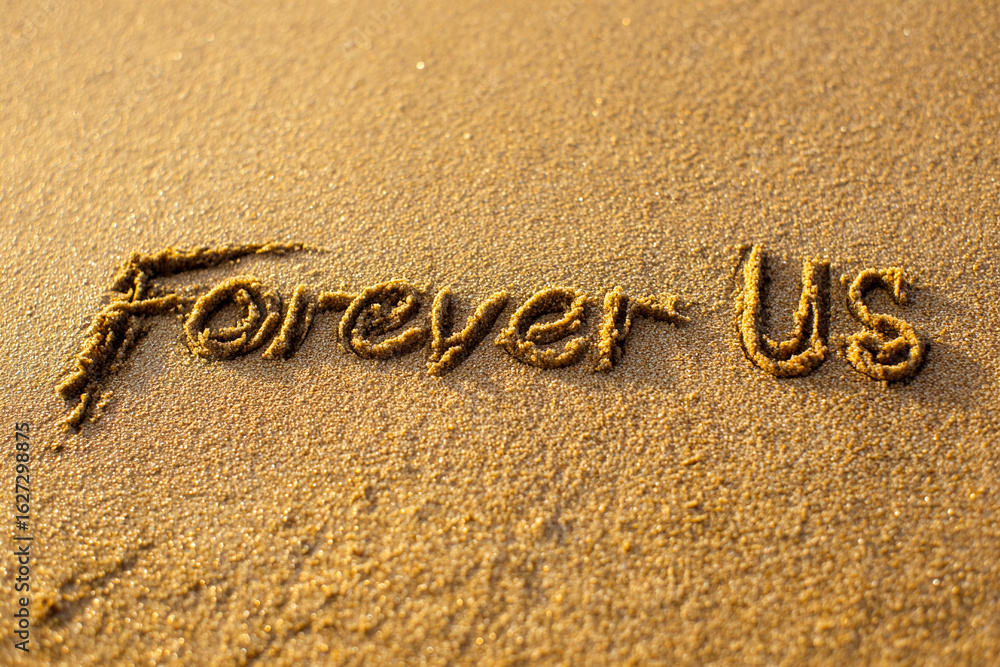 Fototapeta premium Forever Us Written in Golden Sand with Minimalist Hug Illustration and Gentle Wave in Loving Vertical Coastal Scene