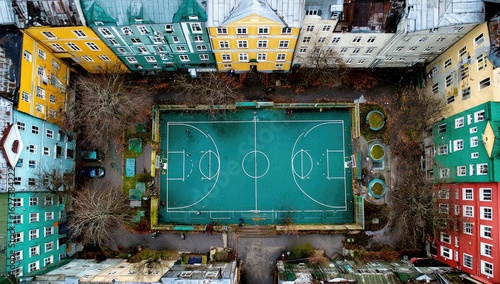 High-angle view of a multi-sport court surrounded by colorful apartment buildings