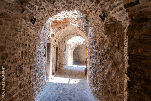 Fototapeta Naklejka Na Ścianę i Meble -  Narrow medieval alley in Mesta Village. Chios Island, Greece.