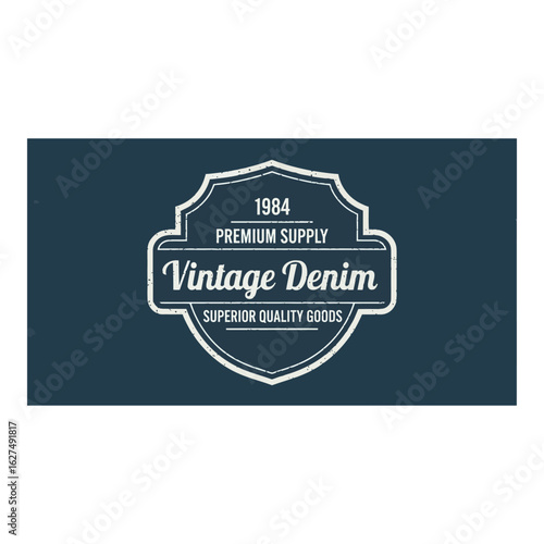 Art of vintage denim emblem with 1984 premium supply and superior quality goods text, suggesting classic style and durable apparel