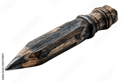 Ancient hand carved wooden point against dark background wooden stake wood craft antique rustic tool