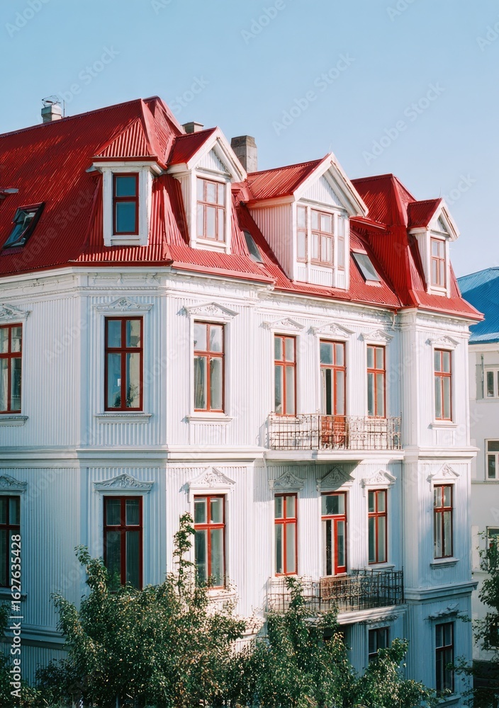 Obraz premium White building with red roof and many windows