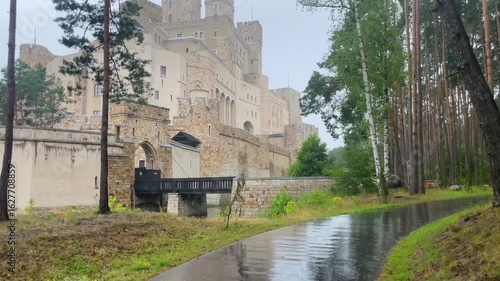 Ground footage of the unfinished Stobnica Castle in Poland, surrounded by forest. Neo-Gothic architecture, massive towers, and dramatic scenery.