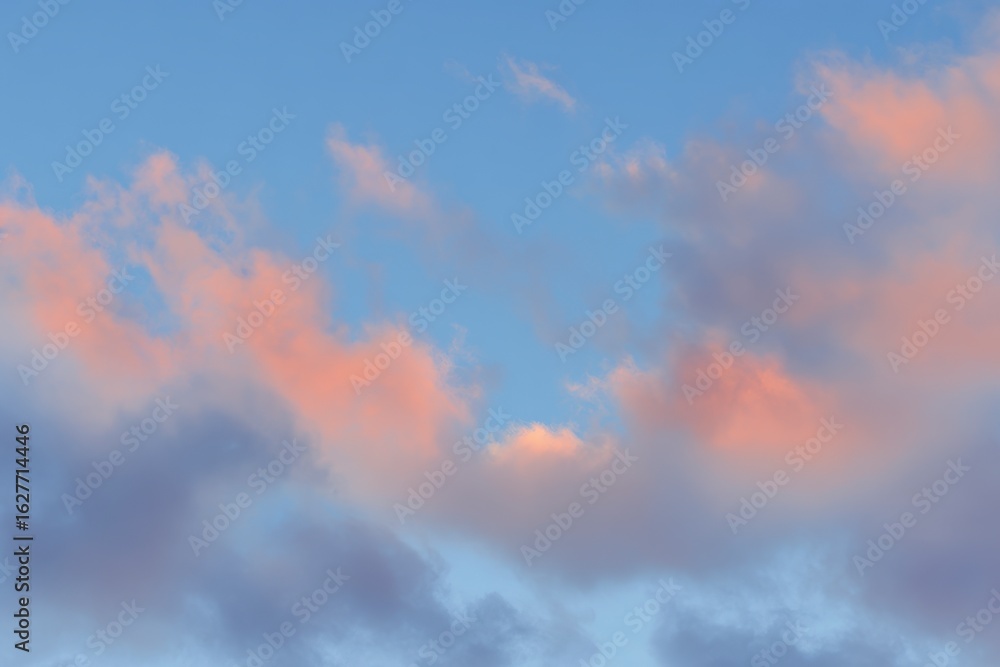 Fototapeta premium Soft, pastel-hued clouds against a vibrant blue sky
