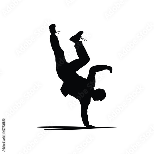 Silhouette of a breakdancer performing a handstand freeze