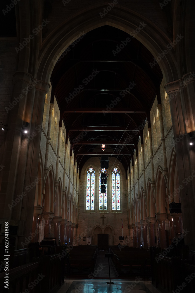 Fototapeta premium Photographs showing the inside of a grand Bermudian church with stone walls, tall arches, and detailed architecture