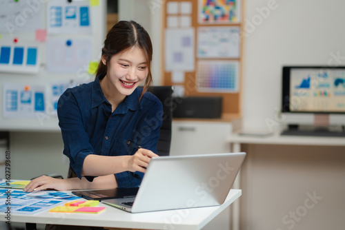 Billede på lærred Female coder or developer working using a computer display and smartphone in problem solving at workplace