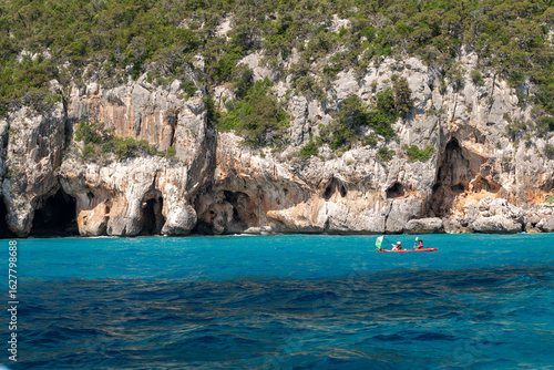 A kayak floating on the sea near the cliffs near Cala Gonone, Sardinia