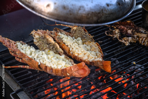 Photography Thai grilled lobster tails cooking on an open grill at a street food market in Chinatown, Bangkok, Thailand