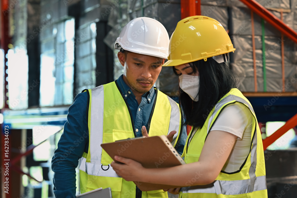 Industrial supervisor and worker discussing document details to ensure operational accuracy Industrial supervisor and worker discussing document details to ensure operational accuracy