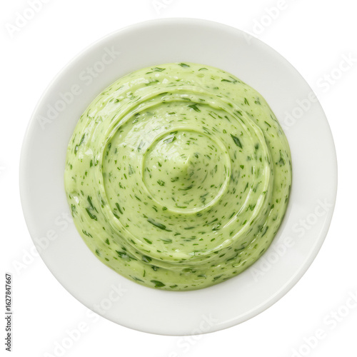 Creamy green herb sauce in a white bowl, garnished with fresh herbs, ideal for culinary use