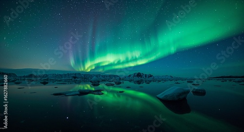 Aurora borealis over a tranquil lake reflecting the vibrant green and blue lights of the night sky