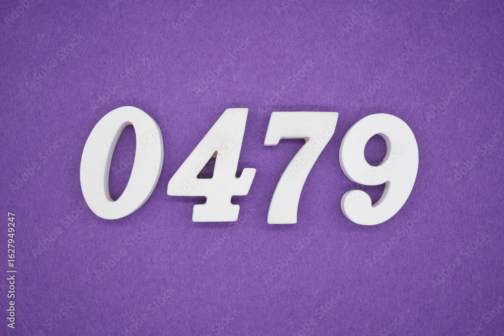 The numbers are made of white painted wood, placed on a purple paper background. The numbers are made of white painted wood, placed on a purple paper background.