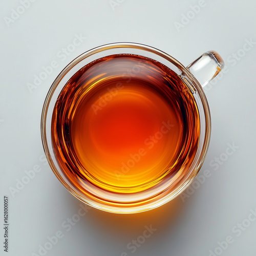 Glass cup of black tea on white background, top view
