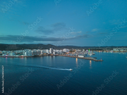 Ciudad Costera y Puerto Deportivo con Luces al Anochecer