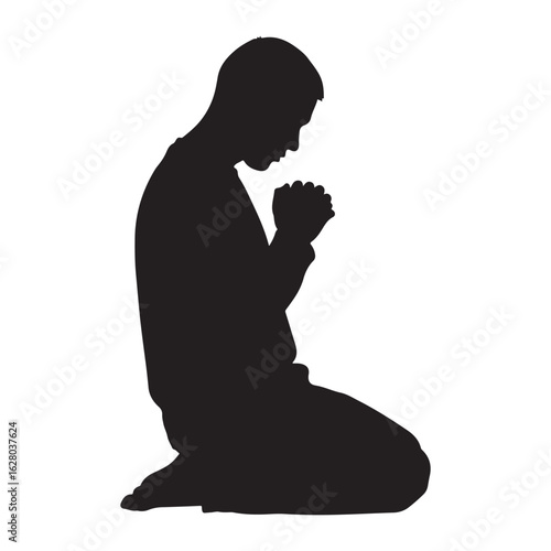 A solitary figure kneeling in prayer captured in a stark black silhouette