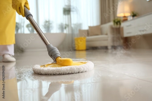 Person cleaning white tiled floor with steam mop
