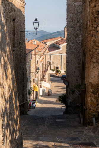 Fototapeta Naklejka Na Ścianę i Meble -  downhill street of the old village at sunset - Rocca Cilento - Salerno - Italy