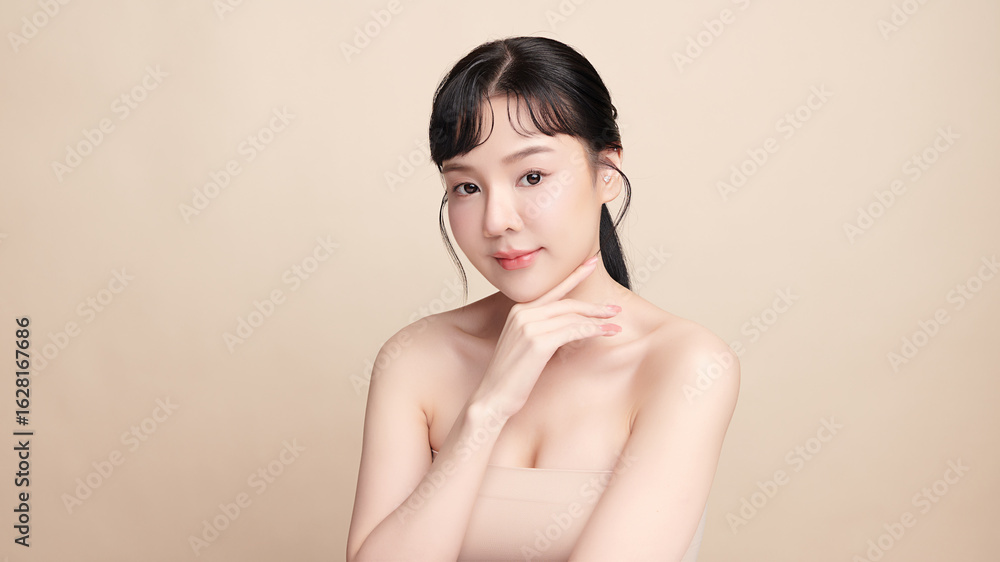 A beautiful young Asian woman with clean, fresh skin against a beige background. Skincare, facial treatment, cosmetology, beauty, and spa. An elegant portrait of an Asian woman. A beautiful young Asian woman with clean, fresh skin against a beige background. Skincare, facial treatment, cosmetology, beauty, and spa. An elegant portrait of an Asian woman.