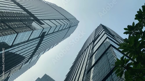 Office tall building. Low angle view of skyscrapers office building in central business district with blue sky