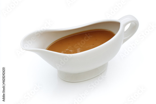 a gravy dish with a spoon in it