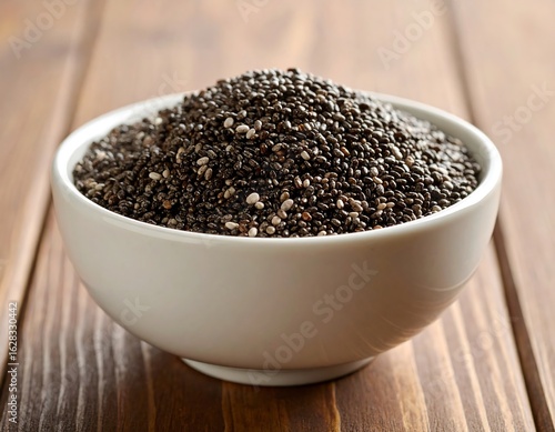 White bowl filled with chia seeds on a wooden table (1)