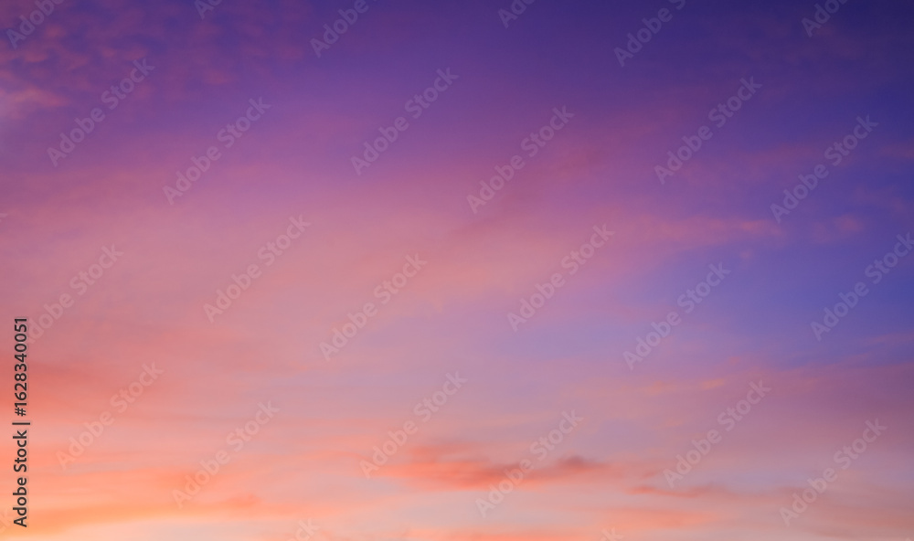 Obraz premium Sky Summer Sunset Background with Nature Light and clouds on Colorful Orange Pink and Blue Fantasy Sunrise Sky, Beautiful Horizon Dusk Sky in the