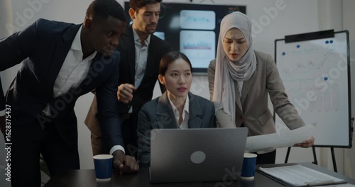 Business concept of 4k Resolution. Businessmen of different nationalities brainstorming together using computers in the office.