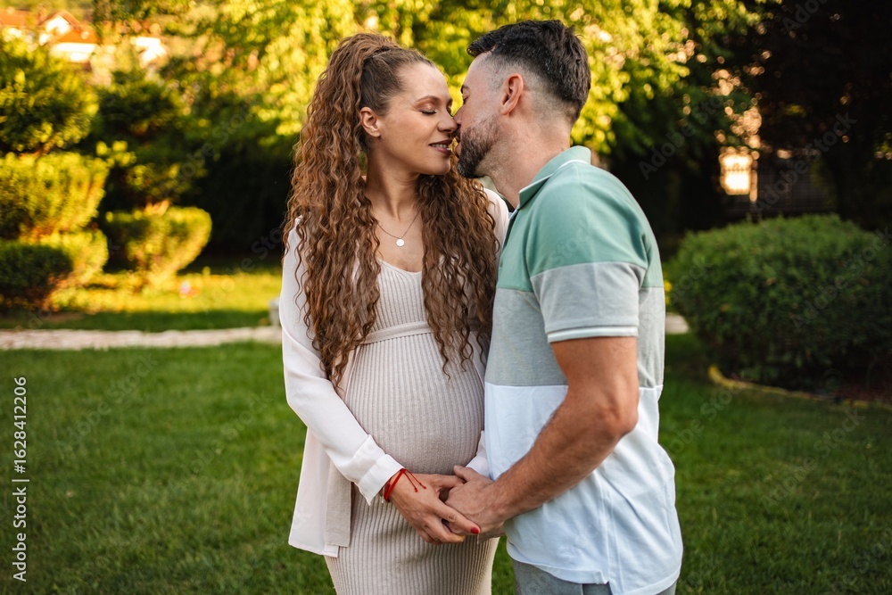 Expecting parents share a tender moment in nature Expecting parents share a tender moment in nature
