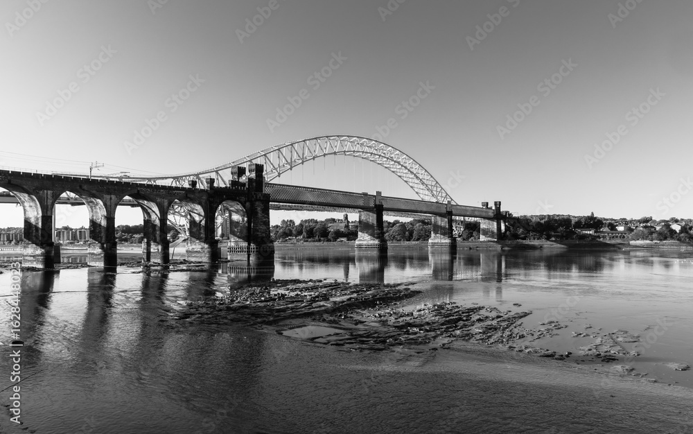 Ethelfleda Railway Bridge and Silver Jubilee Bridge in morning light in black and white Ethelfleda Railway Bridge and Silver Jubilee Bridge in morning light in black and white