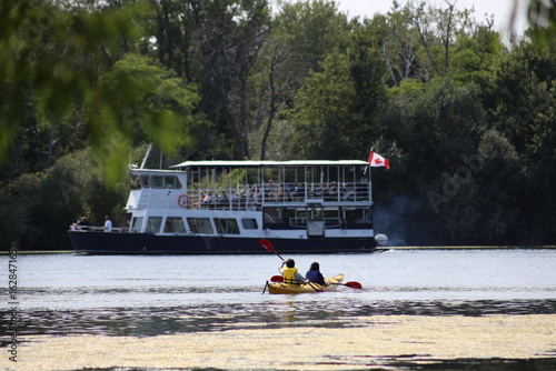 Landscape view of boat and canoe in a lake in Central Island in Toronto. The photo was taken on Central Island on August 2, 2025.
