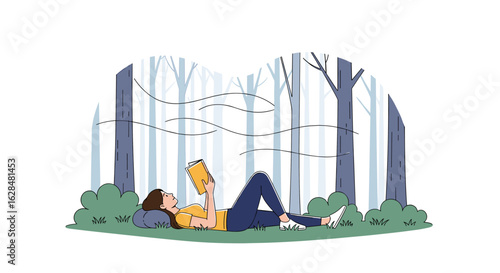 Young woman relaxing in a forest reading a book on a pillow amongst trees and bushes while enjoying nature