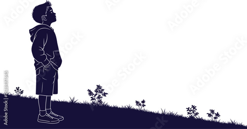 Young boy looks up hopefully on a grassy hill with plants, dreaming of future possibilities