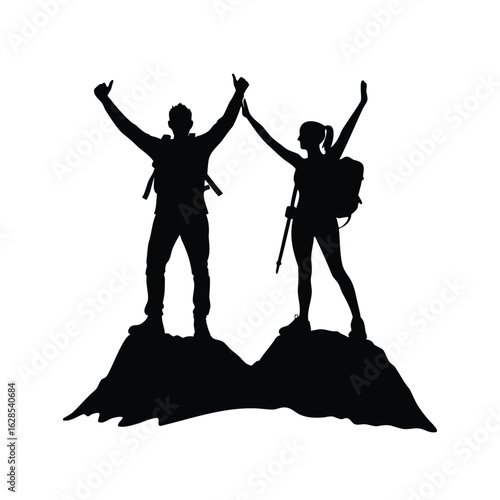 Silhouette of triumphant hikers celebrating reaching the summit of a mountain