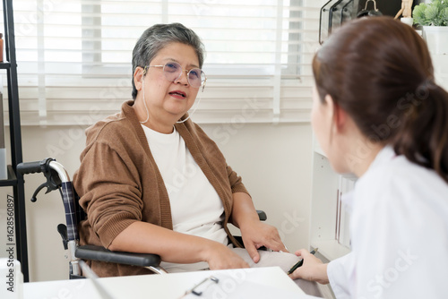 Wallpaper Mural Elderly asian woman smiling gently while talking to female orthopedic doctor during checkup, sharing history of joint pain and showing relief during comforting and reassuring clinical session Torontodigital.ca